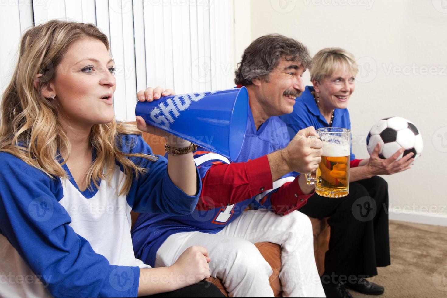 Group of diverse friends playing game on mobile phone Stock Photo