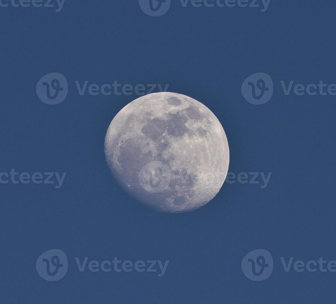 Moon in blue sky photo