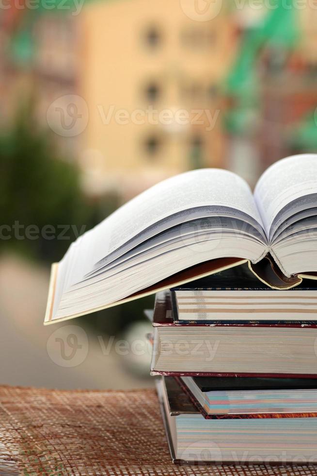 stack of books on city background photo