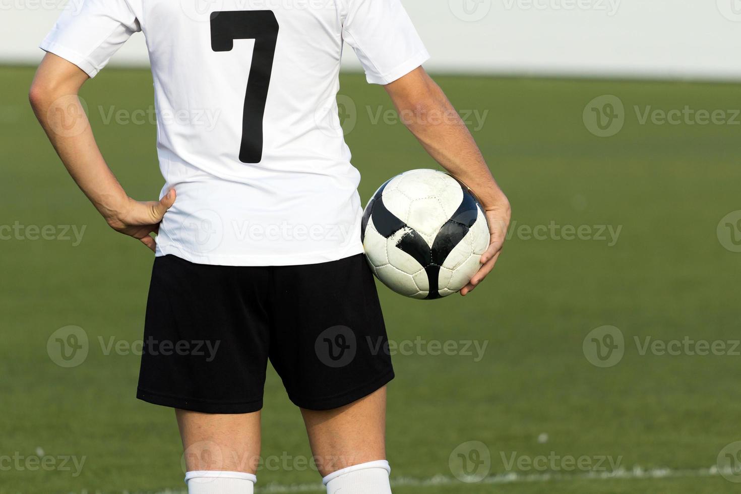 Soccer player with ball, outdoors photo