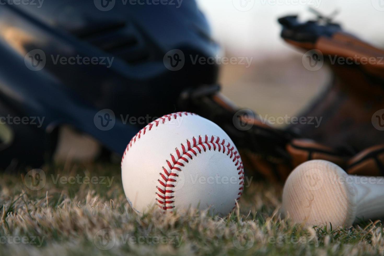 Wooden bat and baseball helmet photo