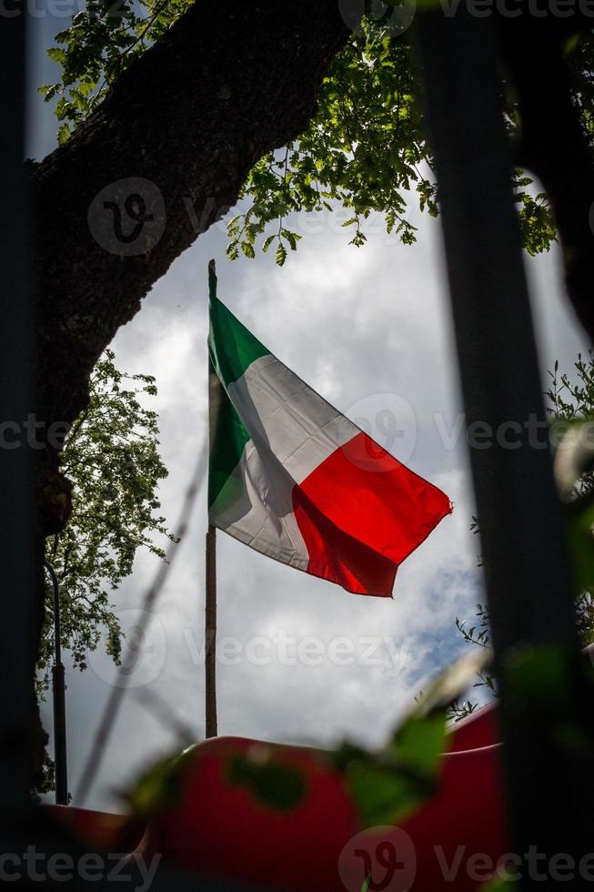 Italian flag agains the sun photo