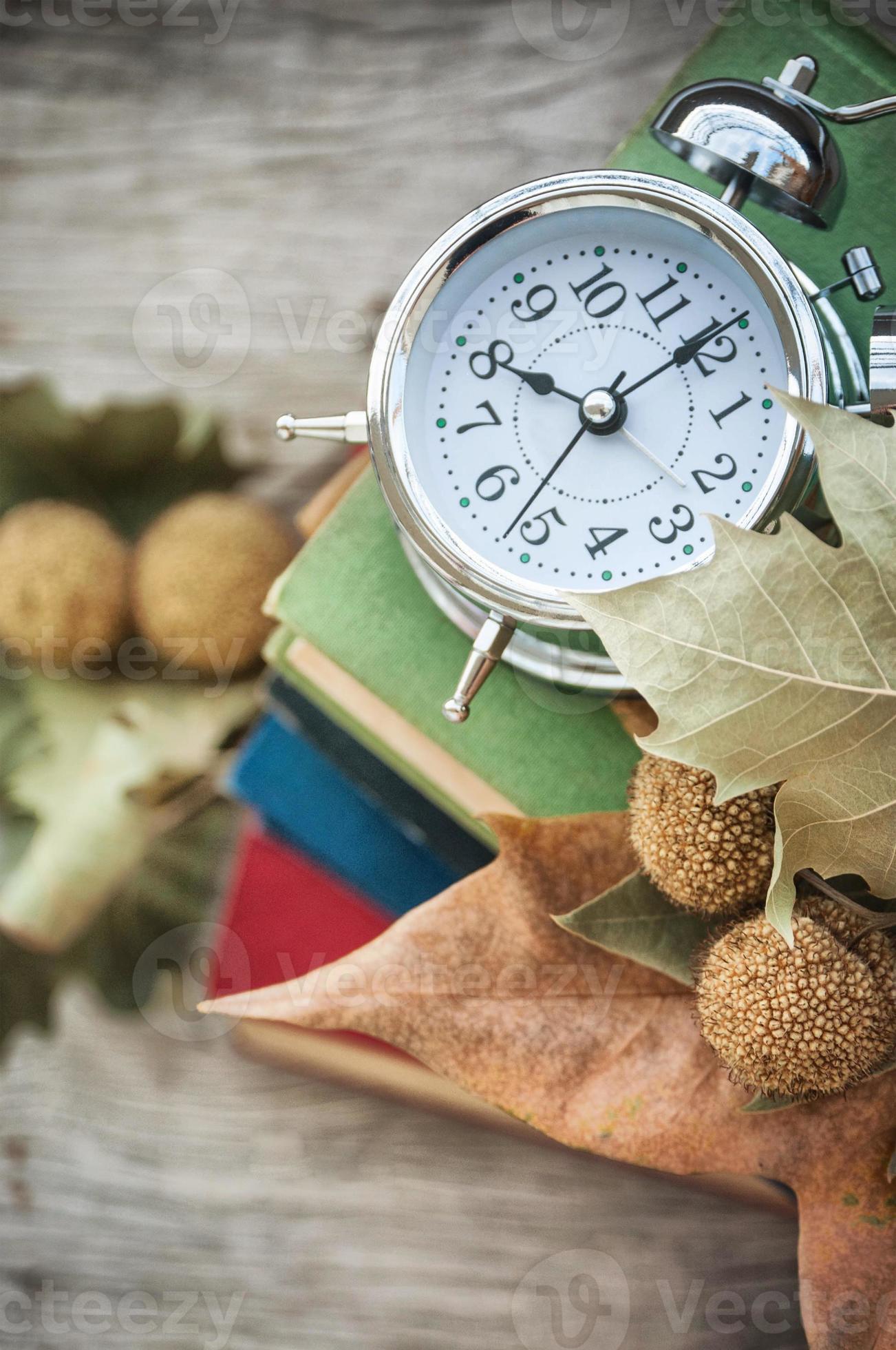 Clock with books 936741 Stock Photo at Vecteezy