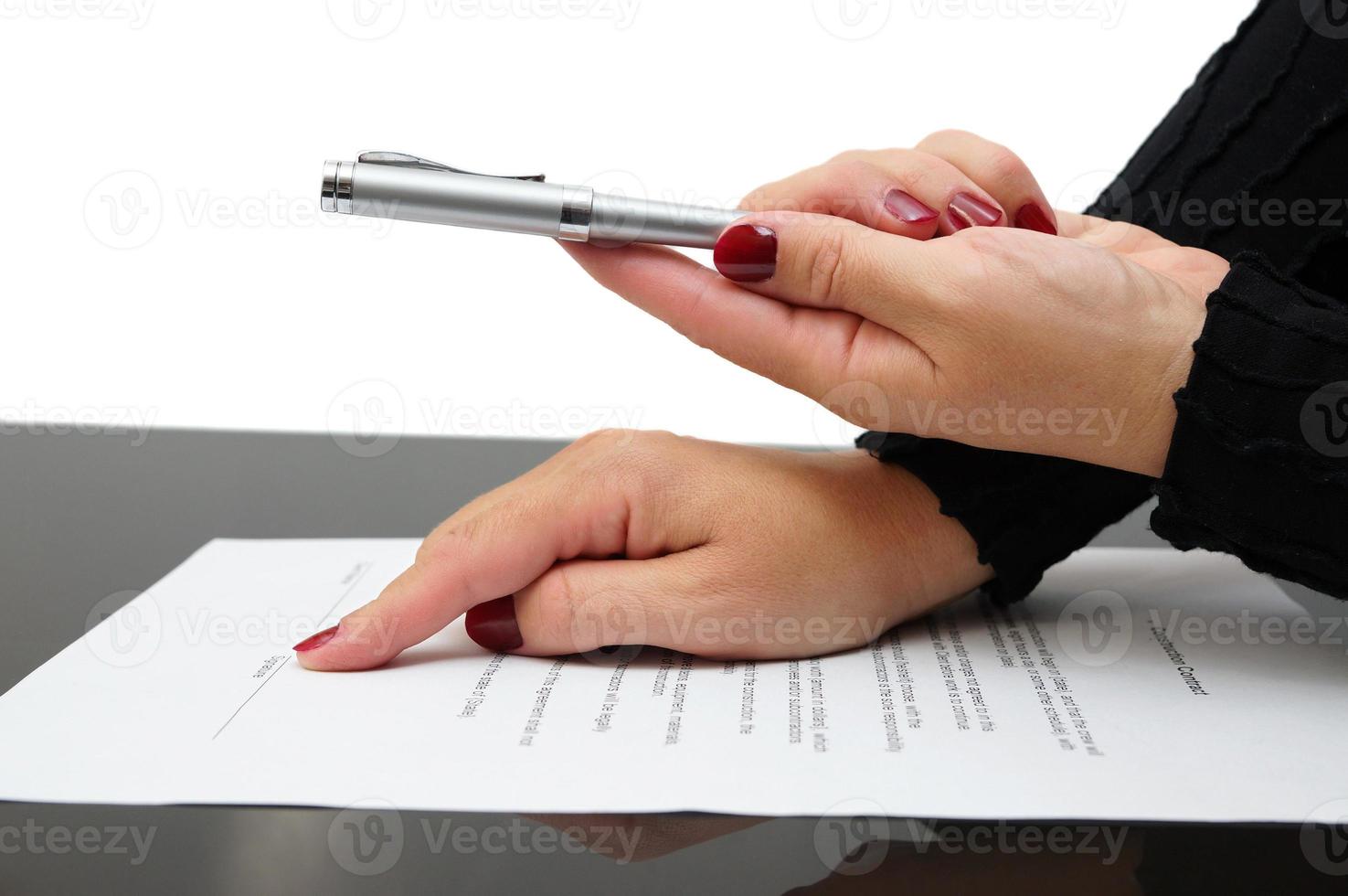 Businesswoman offering  a pen to sign an agreement photo