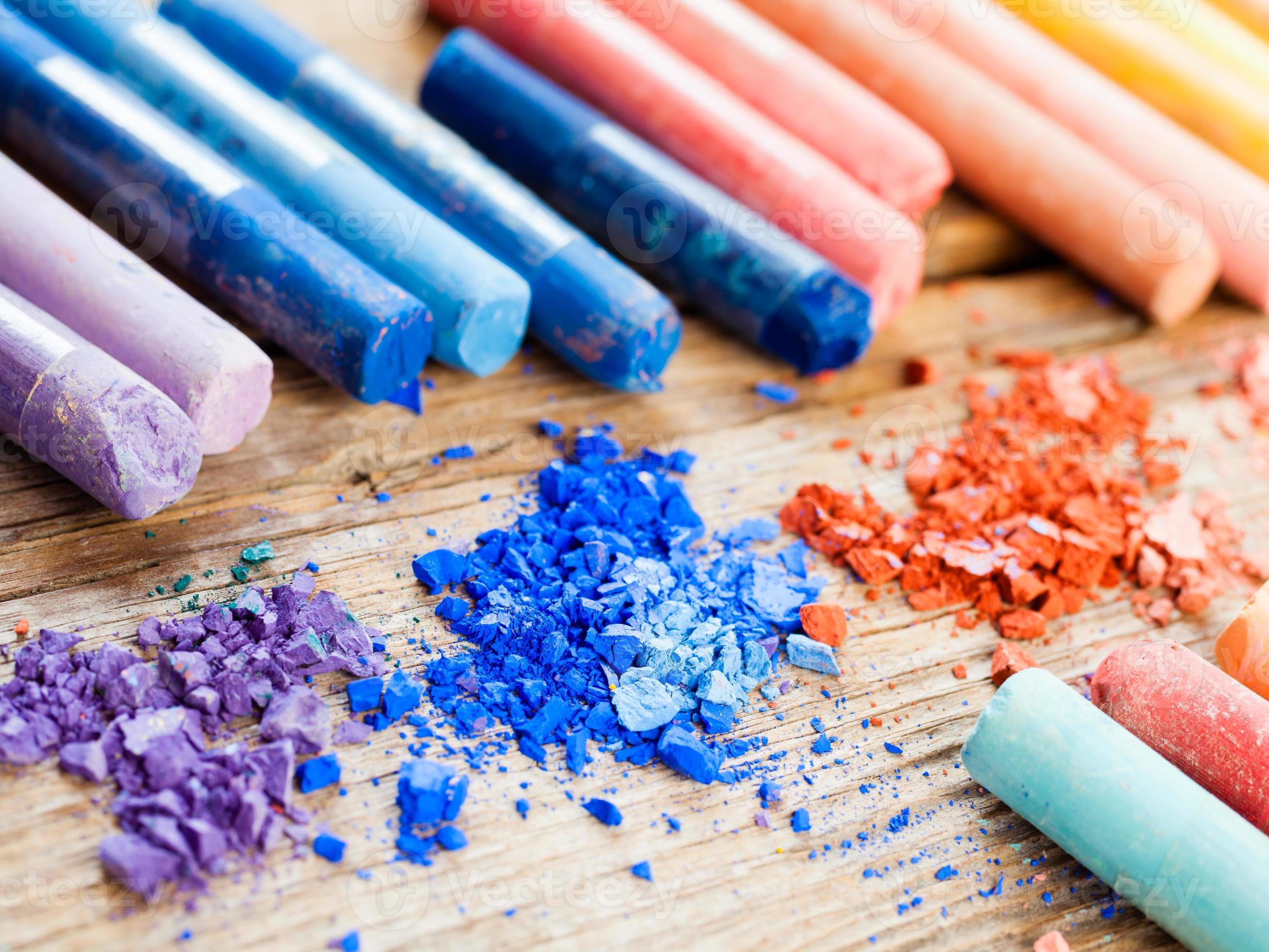 Rainbow colored pastel crayons with crushed chalk close up 937668 Stock