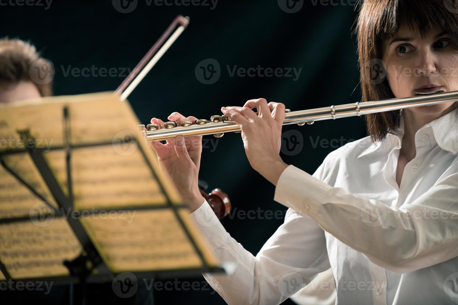 Professional flutist on stage photo