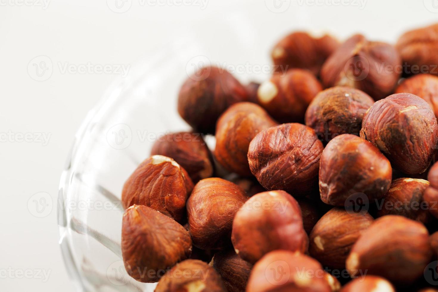 Bowl of hazelnuts on a white background photo