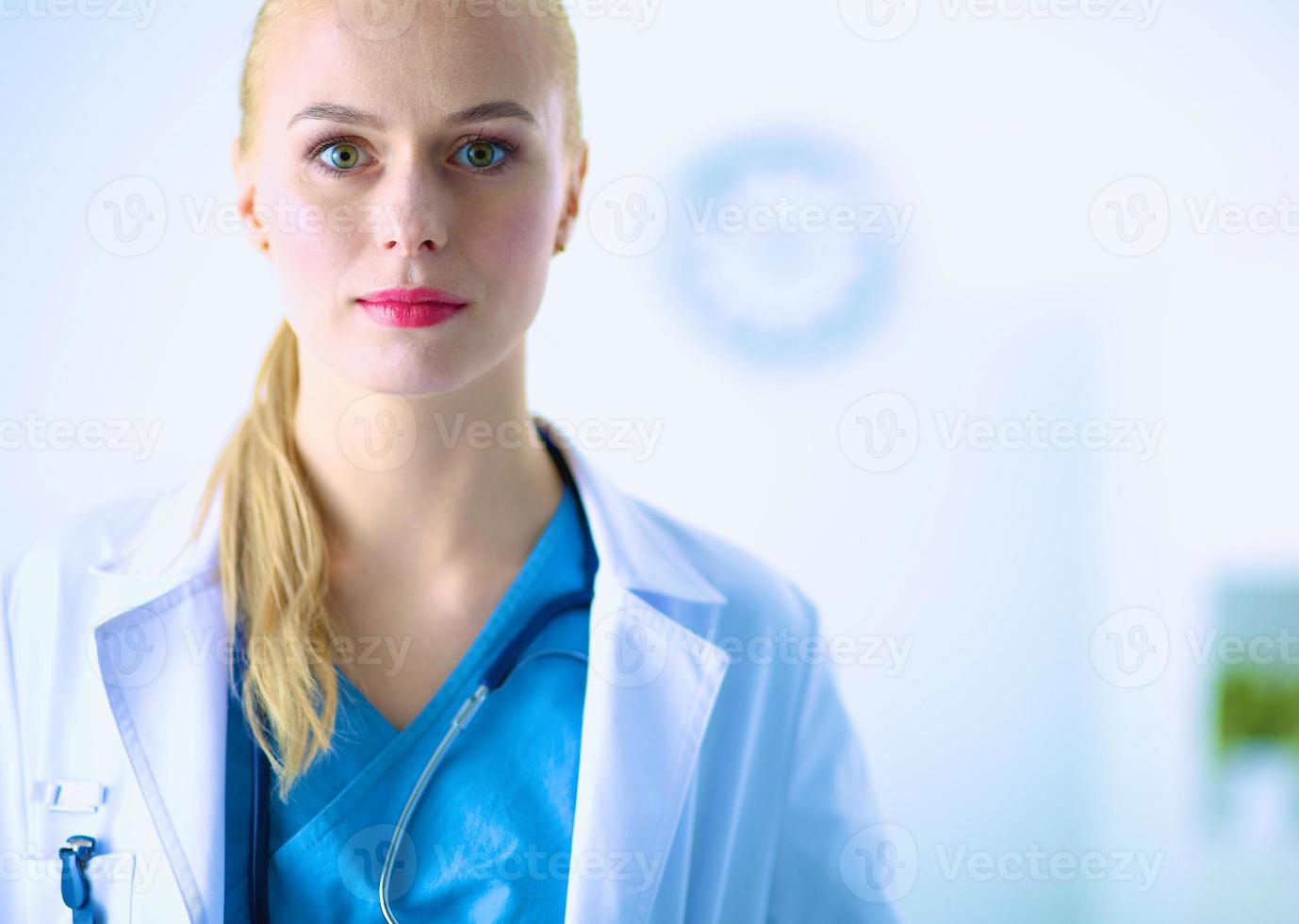 Woman doctor standing with stethoscope at hospital photo