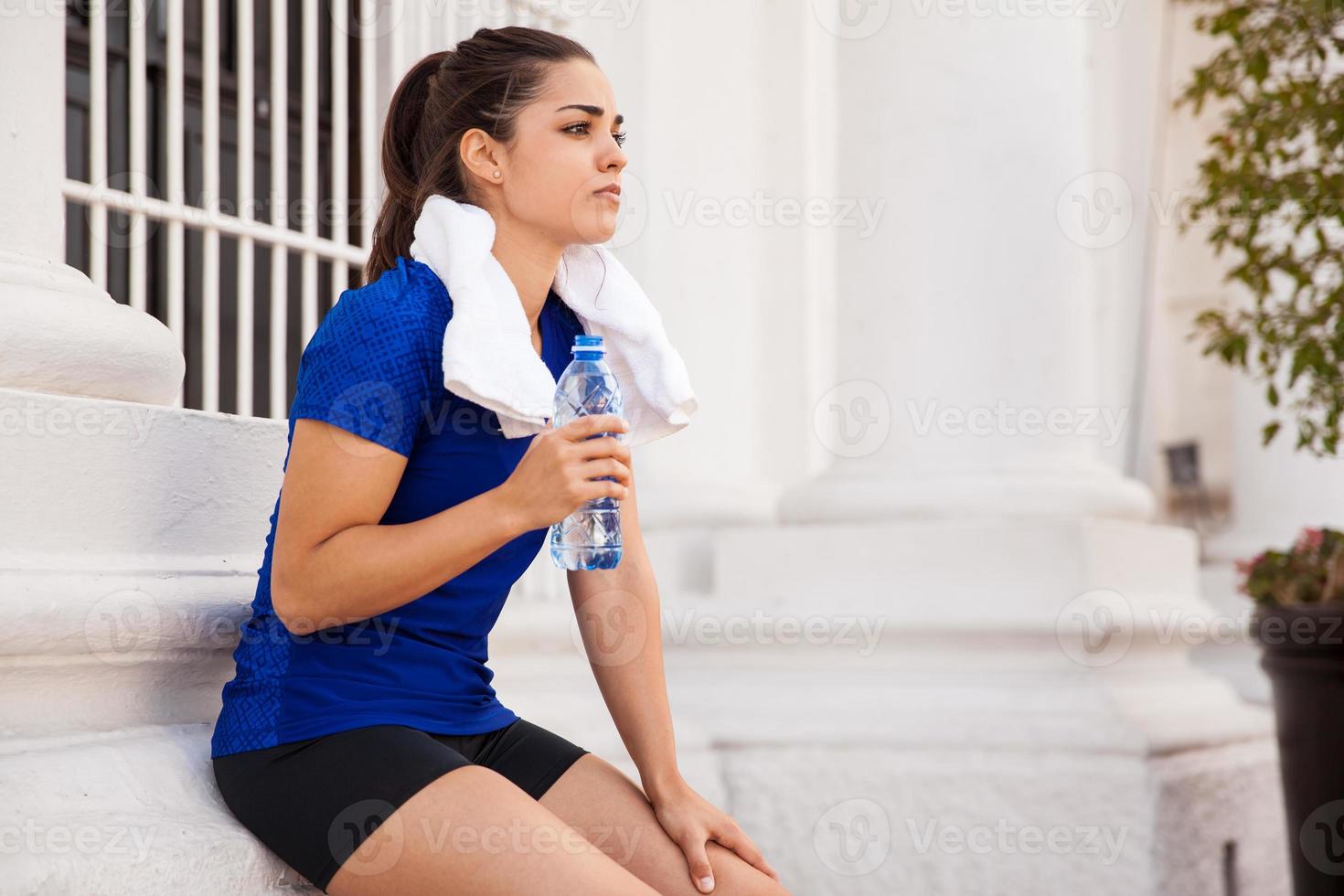 Active woman drinking water photo