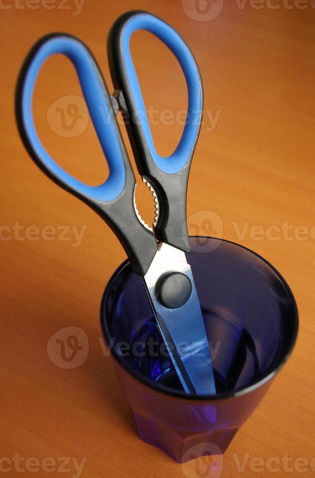 scissors in drinking glass photo