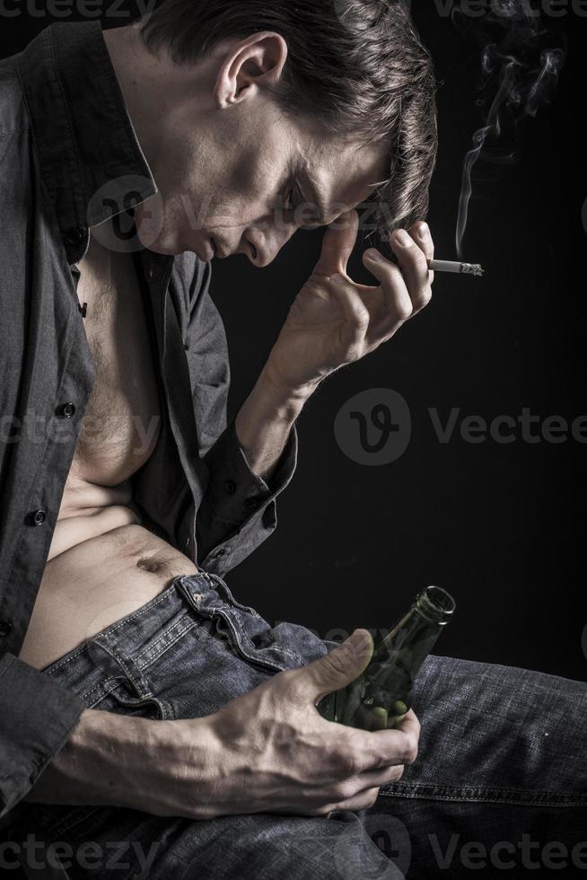 Smoking, beer drinking, depressed man photo