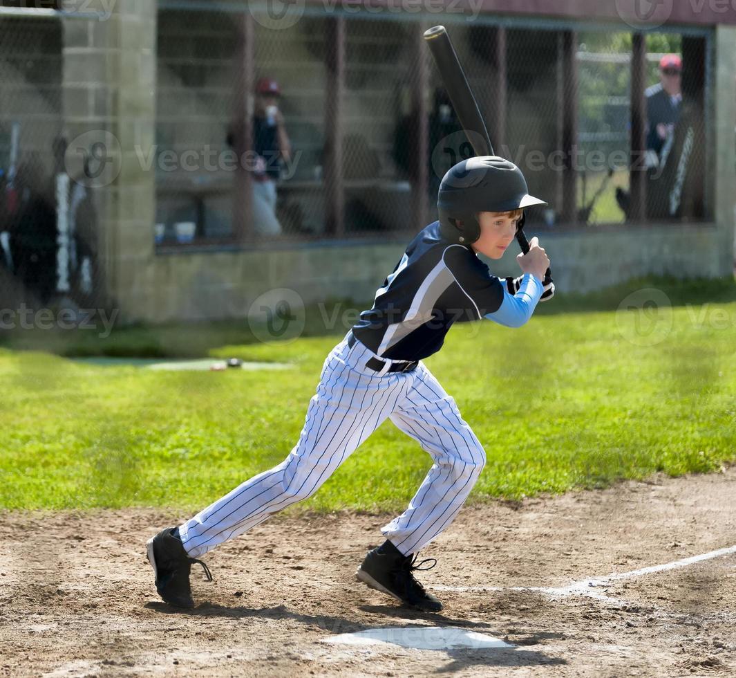 Little League Batter In Action at home plate photo