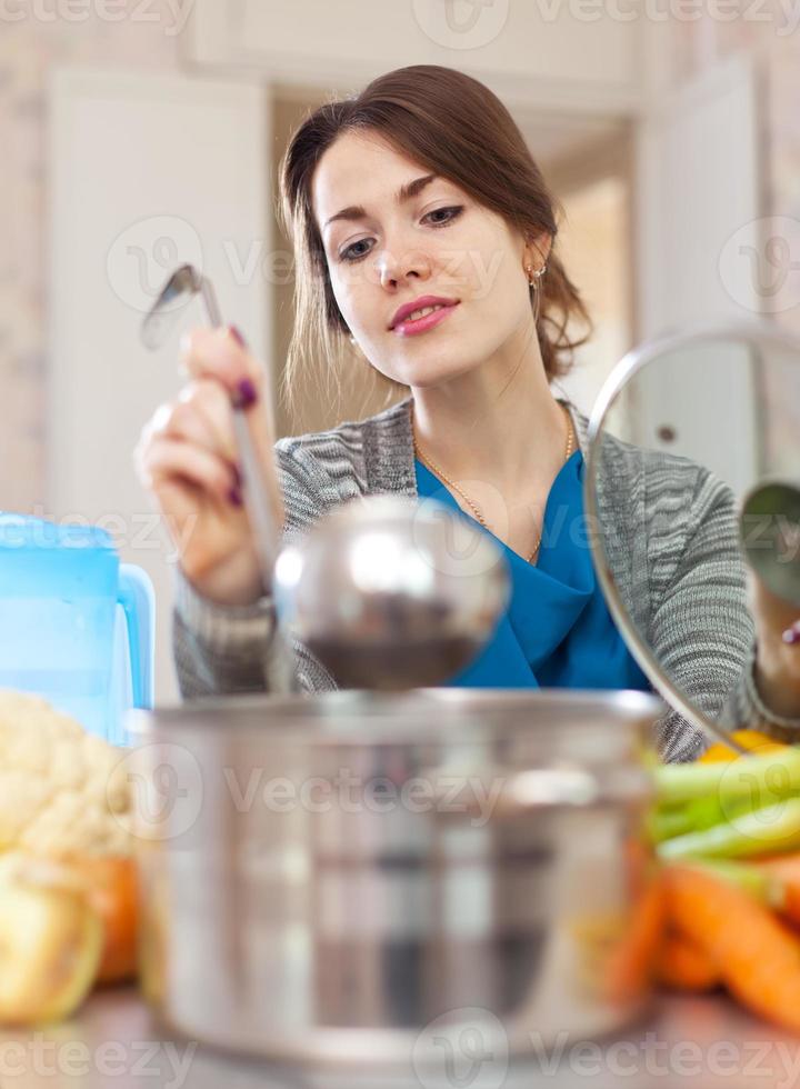 beautiful woman cooking with ladle photo