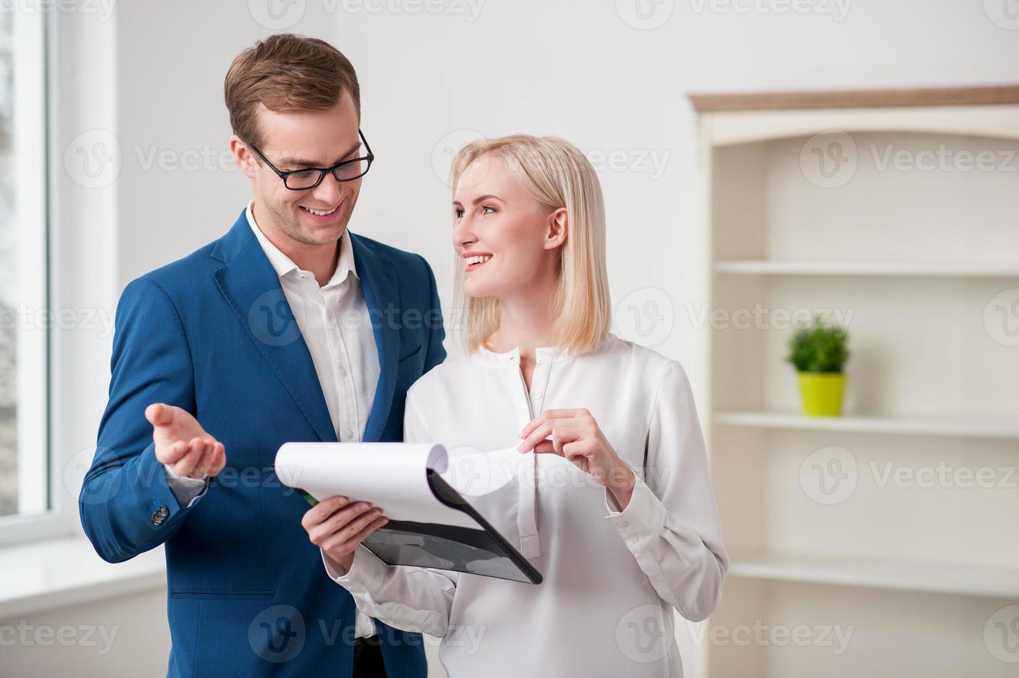 Cheerful estate agent is talking with a customer photo