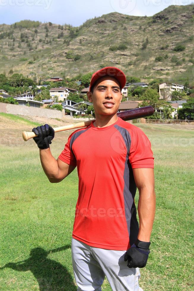 Baseball player casually poses in a field photo