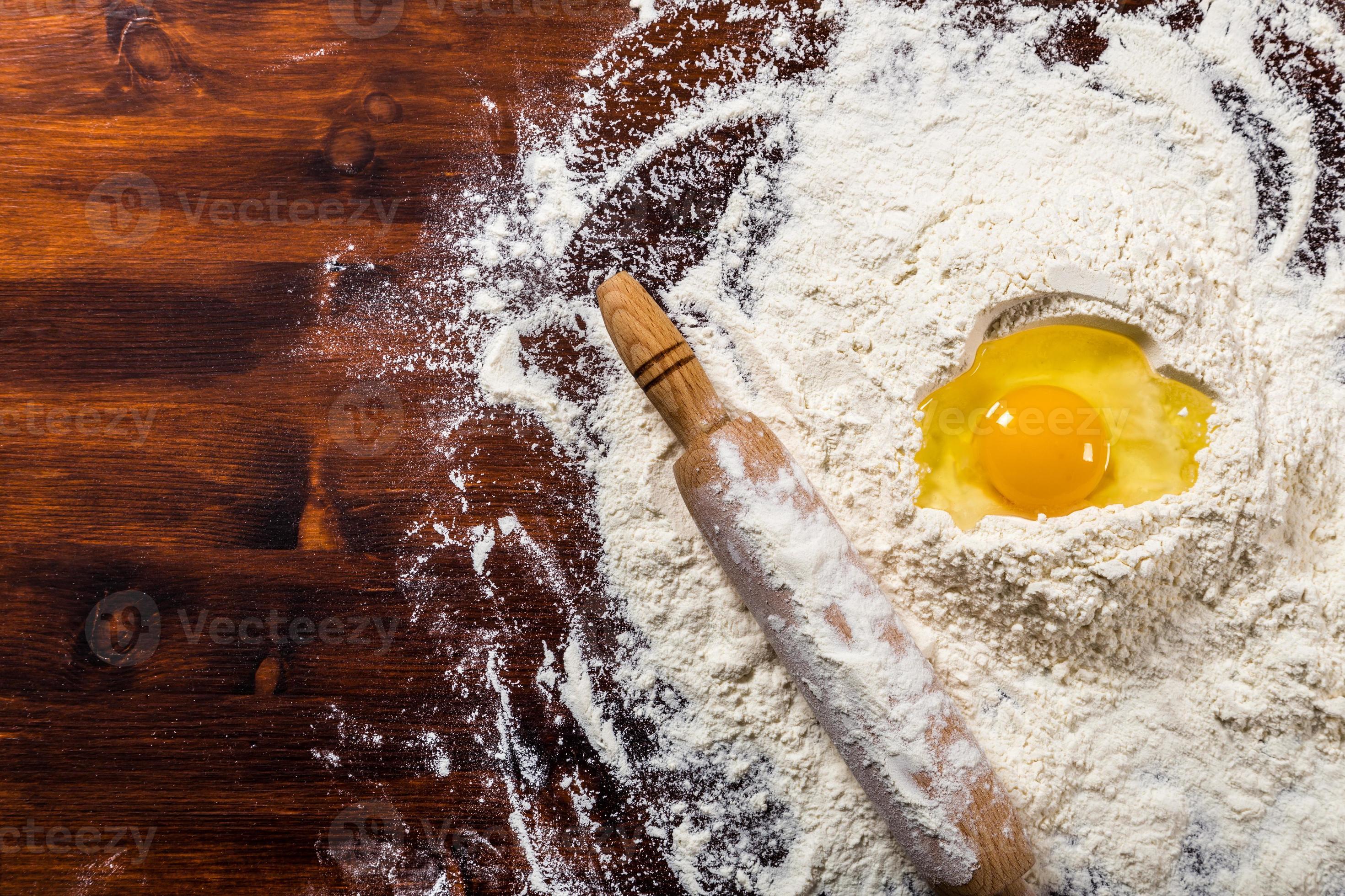 Flour, egg and rolling pin with copy space photo
