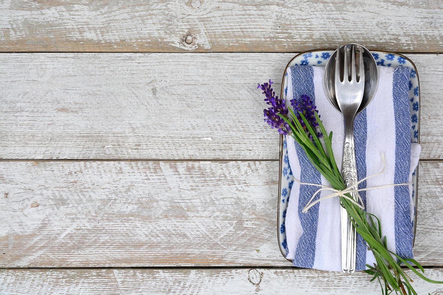 silver cutlery on blue white lavender napkin with  copy space photo