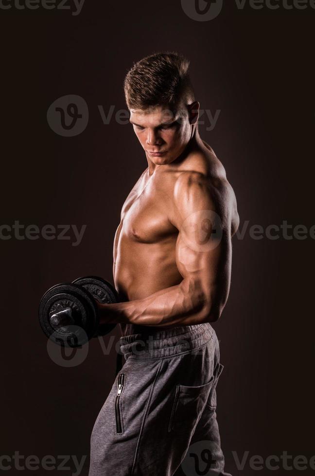 bodybuilder man holding weights photo