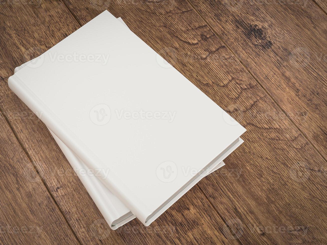 Empty white book mockup template on wood background photo