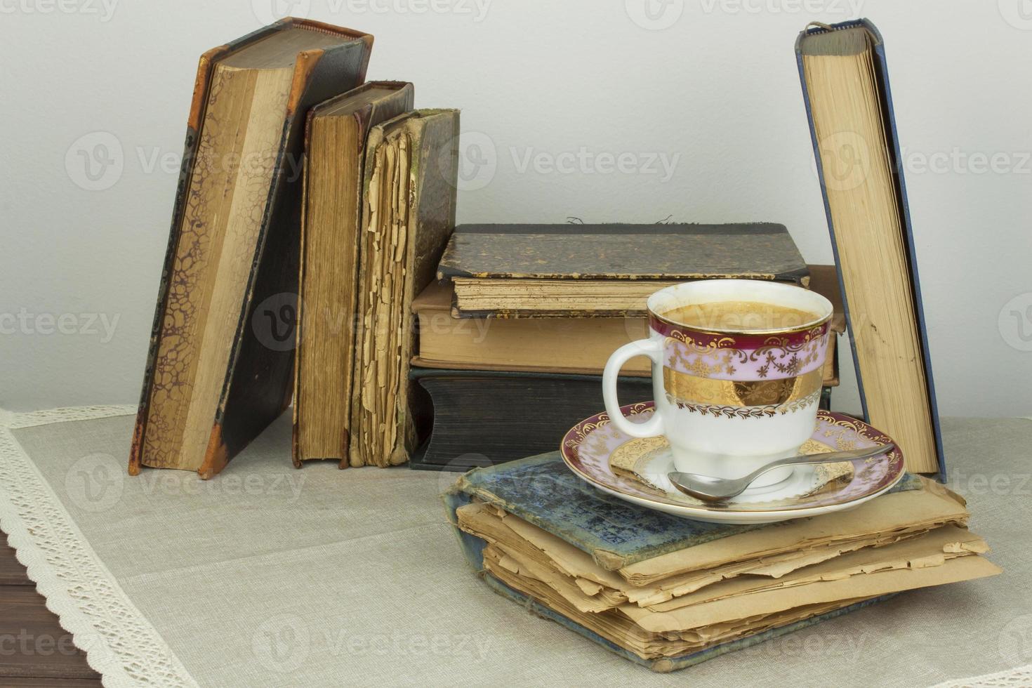 Porcelain cup of coffee and old books photo