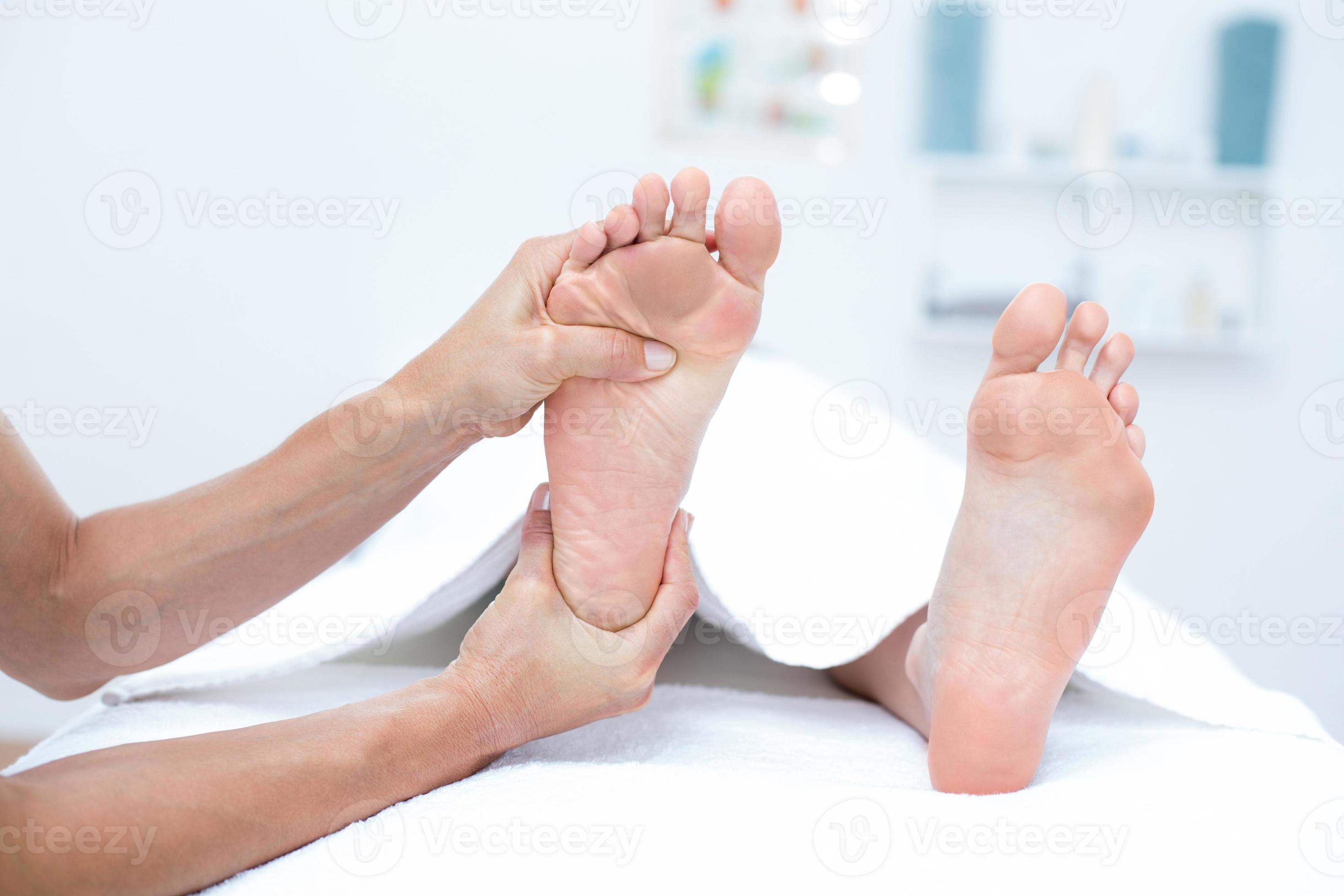 Physiotherapist doing foot massage photo