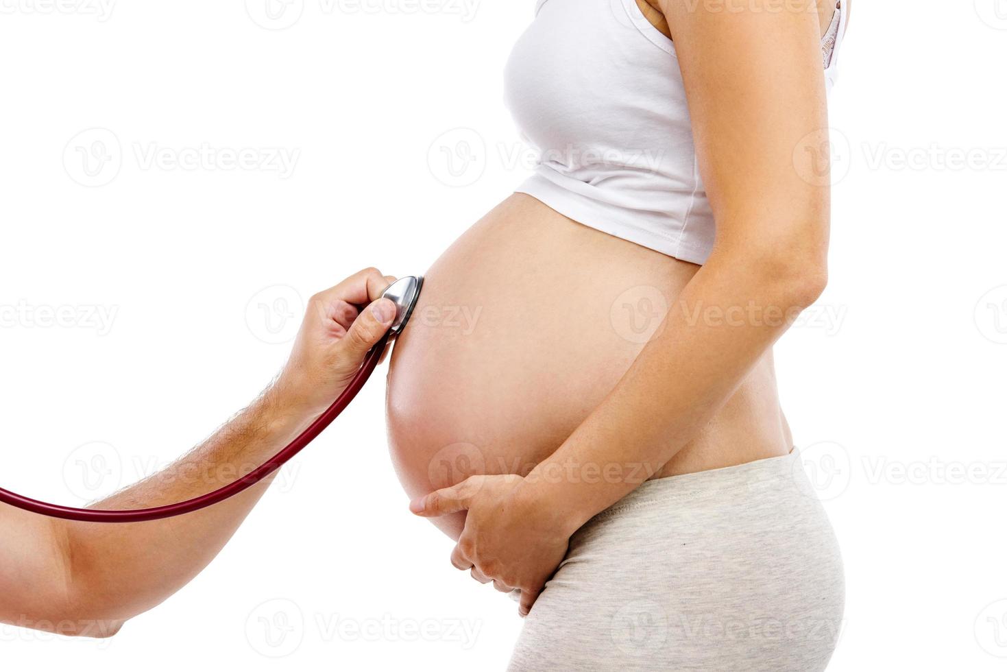 Pregnant woman with doctor isolated on white photo