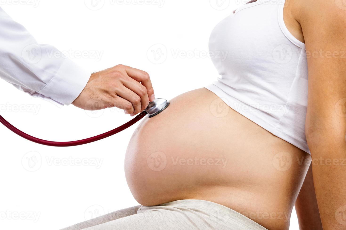 Pregnant woman with doctor isolated on white photo