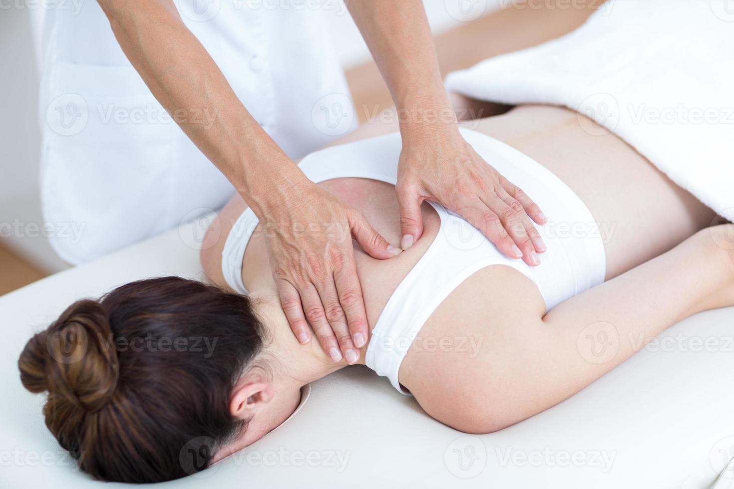 Physiotherapist doing shoulder massage photo