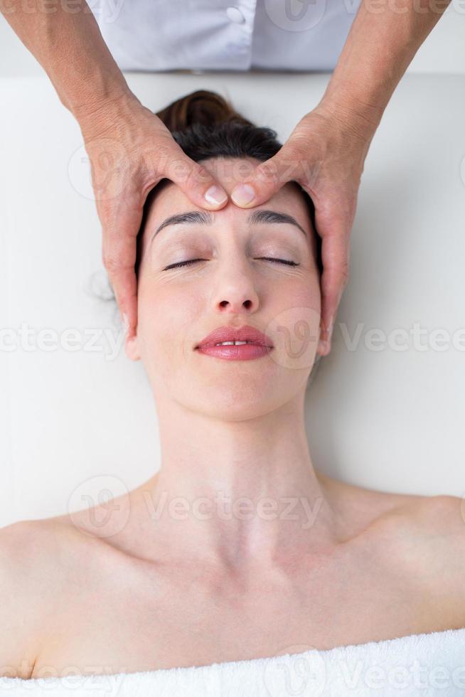 Physiotherapist doing head massage photo