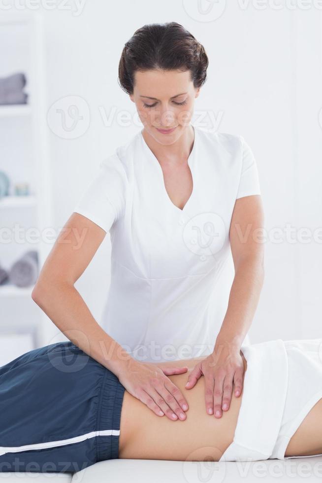 Physiotherapist doing back massage photo