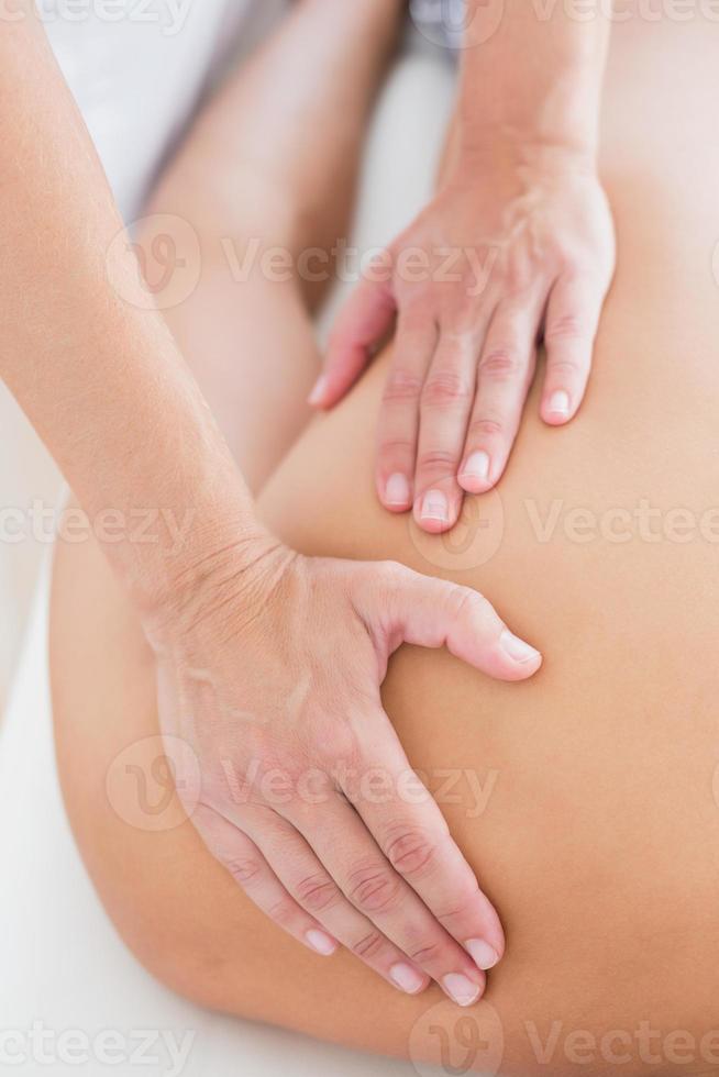 Physiotherapist doing shoulder massage to her patient photo