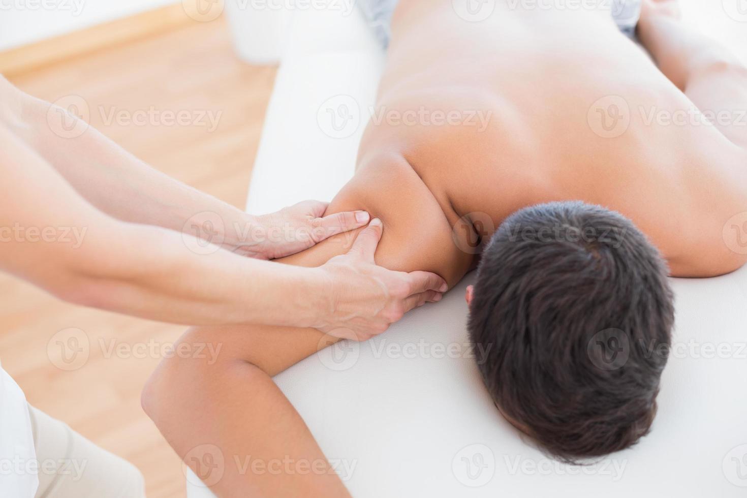 Physiotherapist doing arm massage to her patient photo