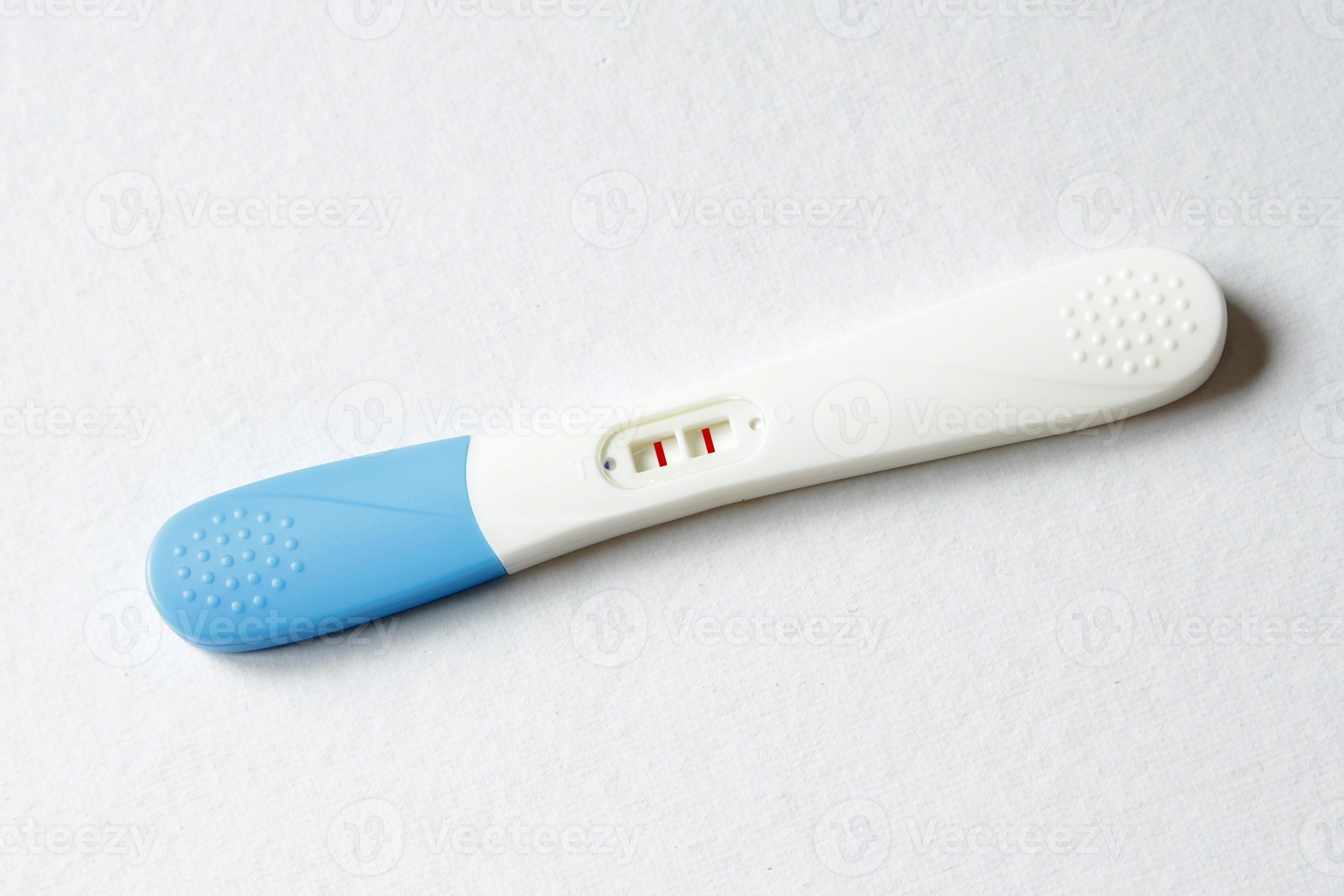 pregnancy test positive result on clinic table 956481 Stock Photo at