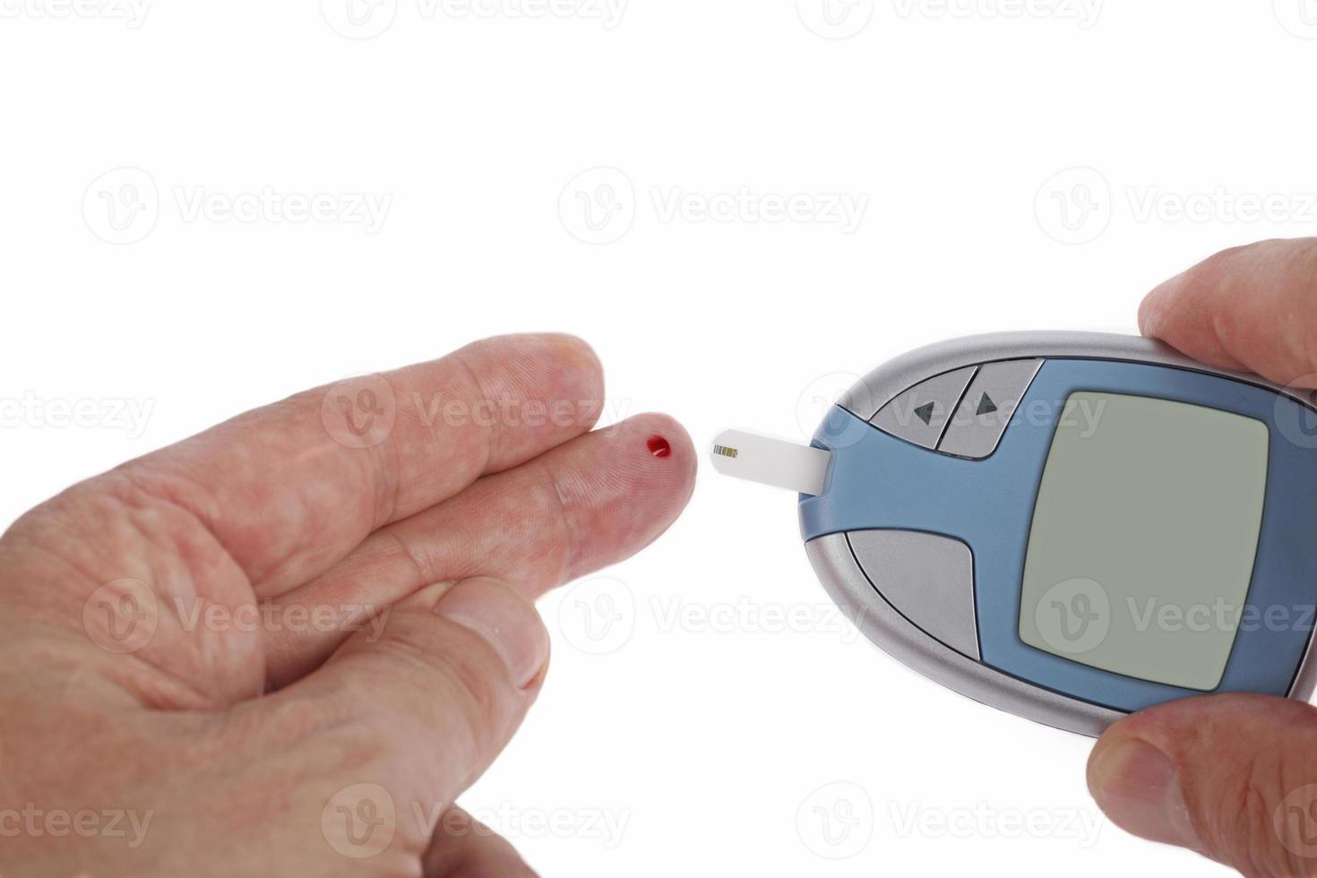 Man testing blood sugar level close up photo