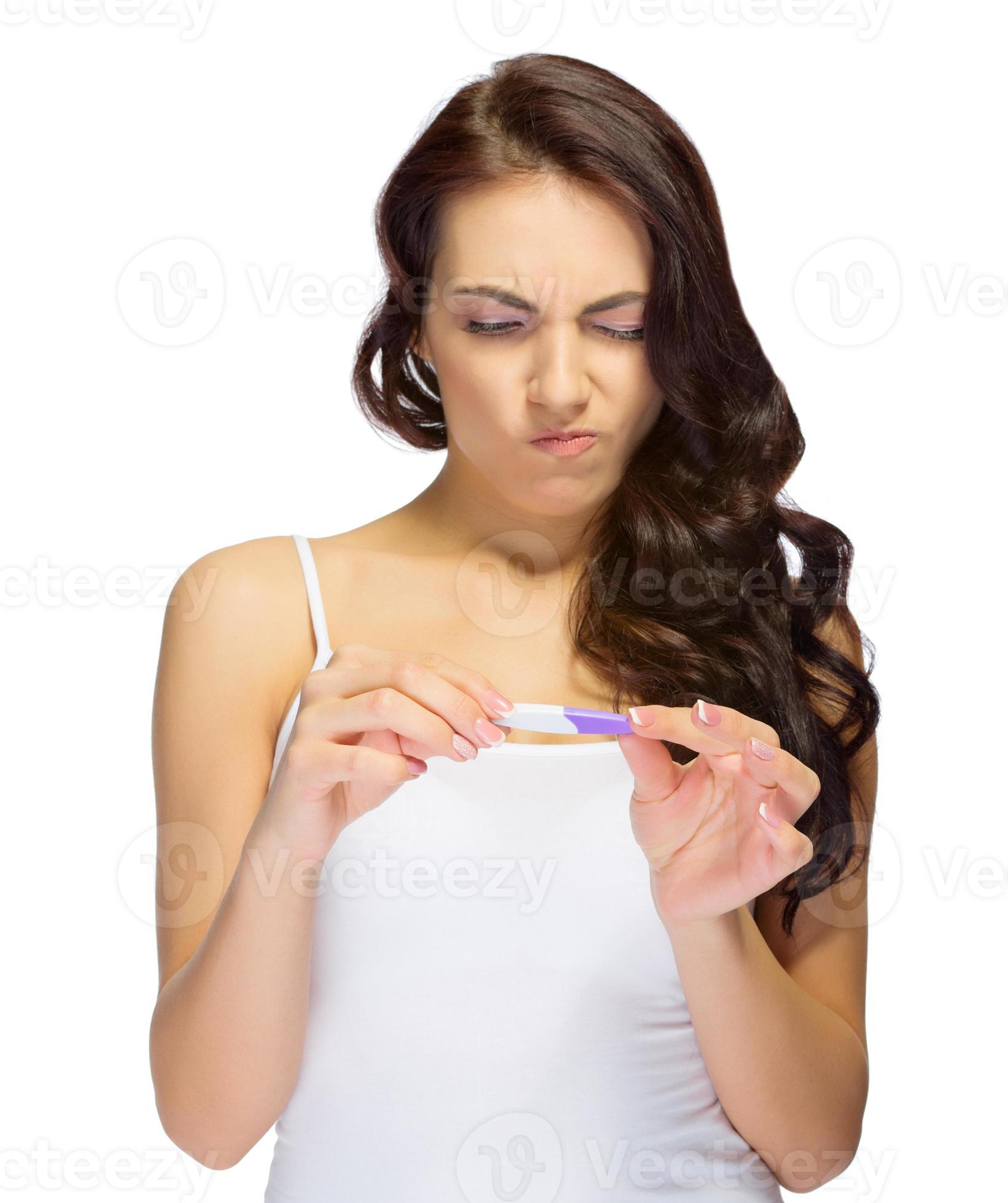 Displeased girl with pregnancy test photo
