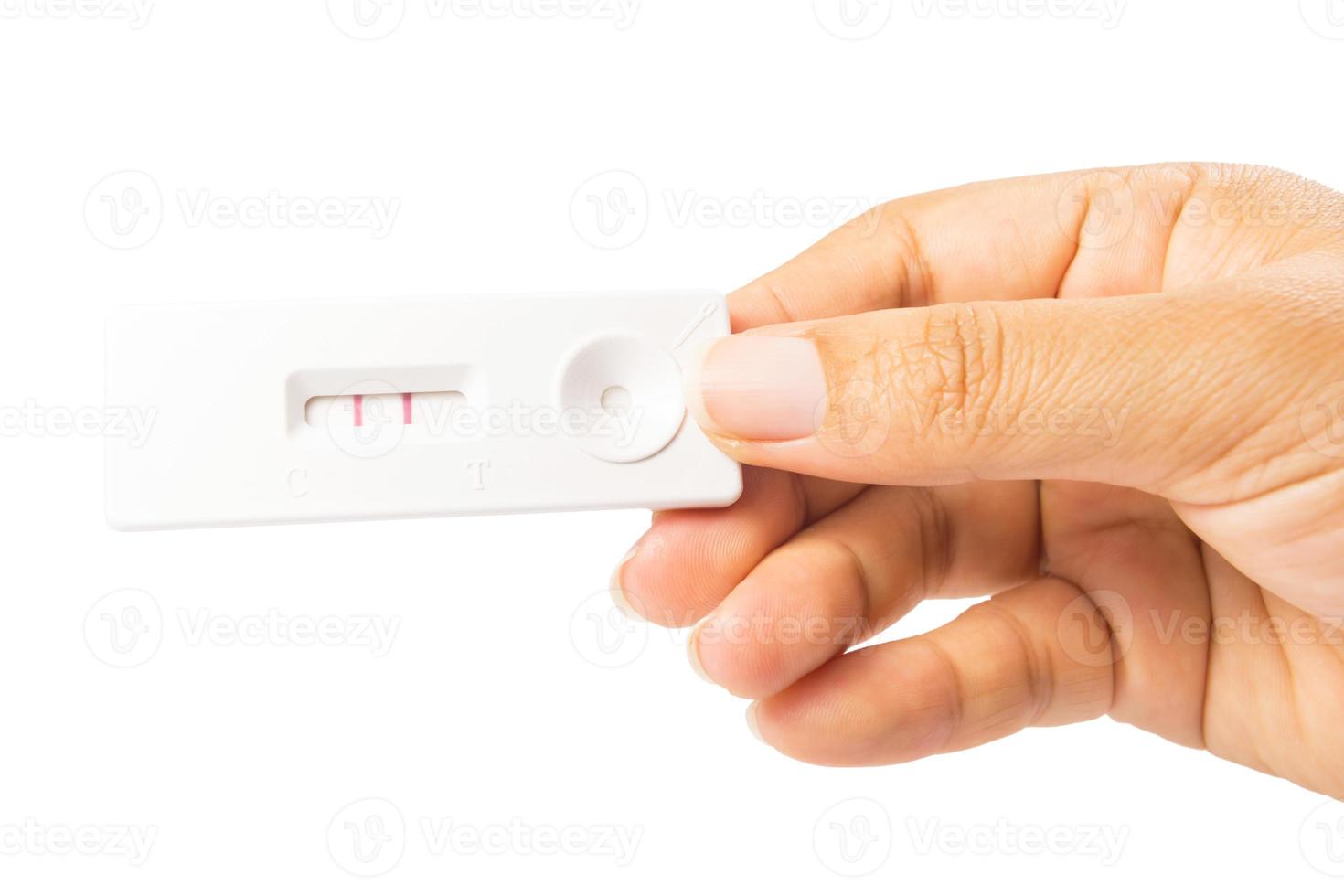 pregnancy test in hand isolated on white photo