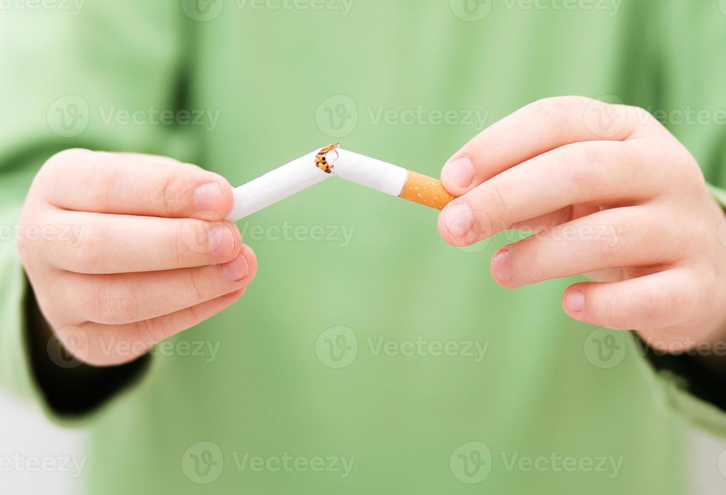 Young girl is breaking a cigarette photo