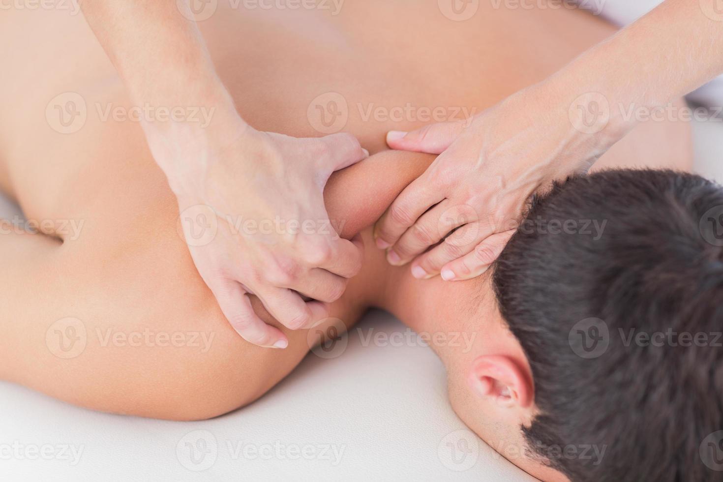 Physiotherapist doing neck massage to her patient photo