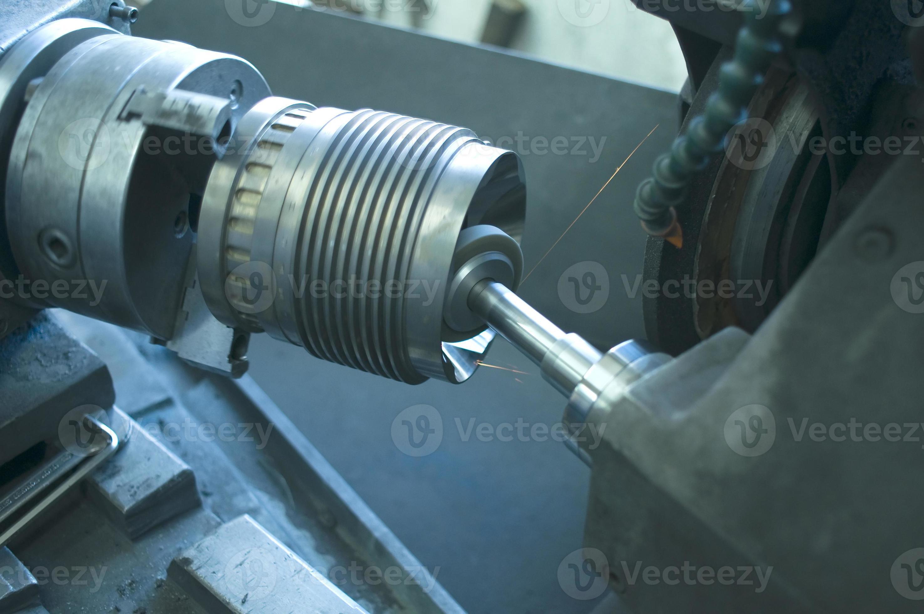 Machining lathe turning steel in a manufacturing plant photo