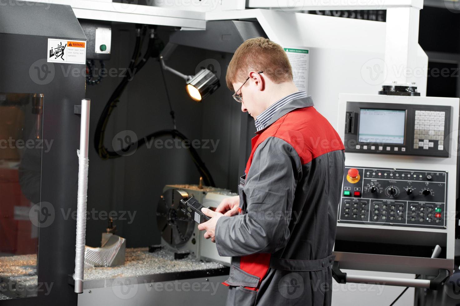 worker at machining tool workshop photo