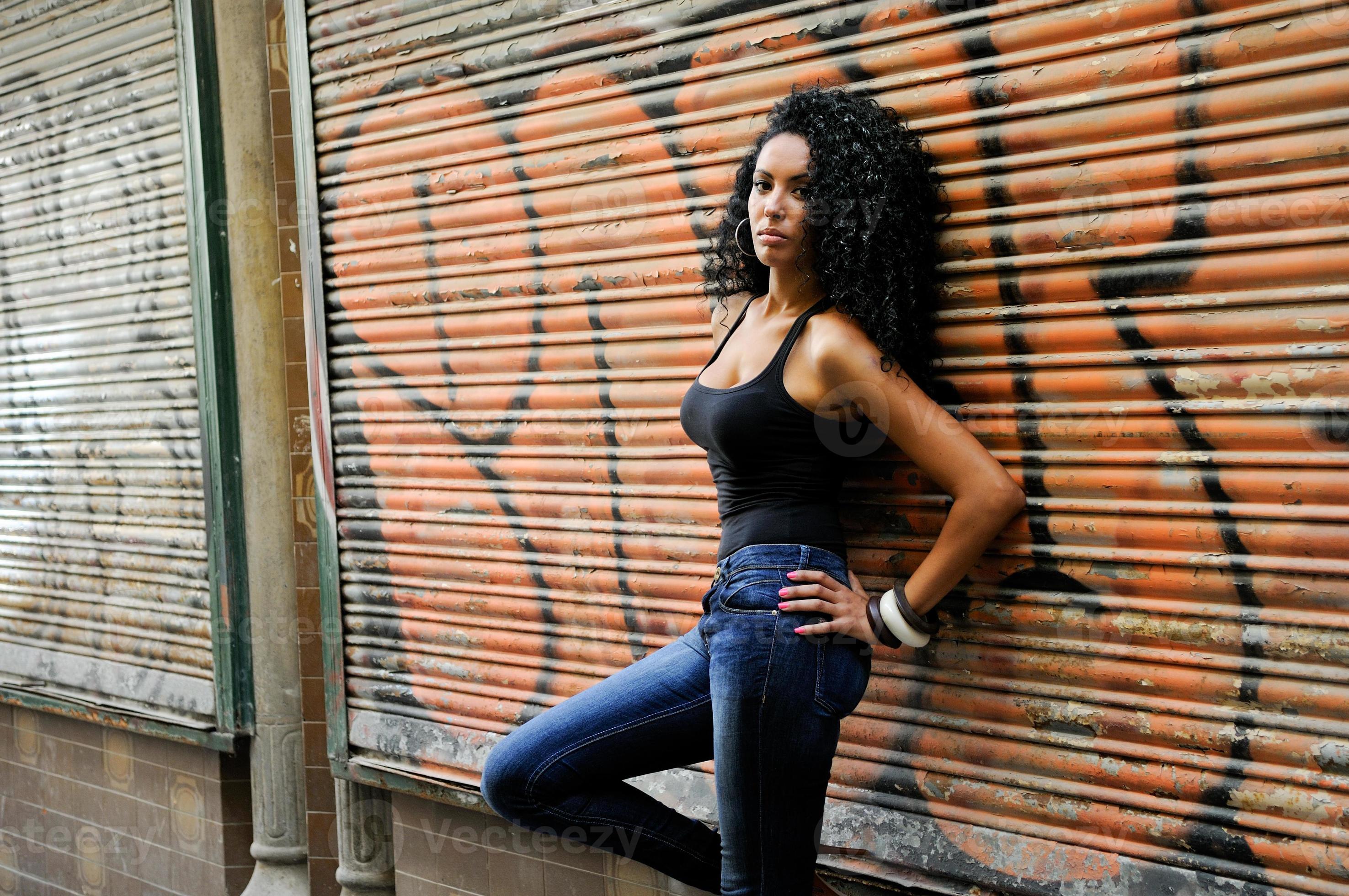 Black woman with afro hairstyle in urban background photo