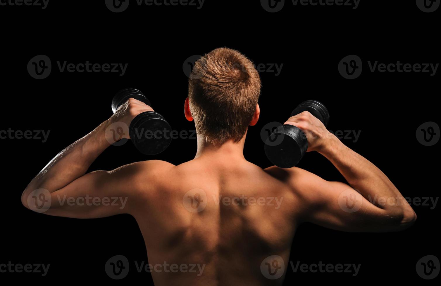 Fitness man with dumbbells photo