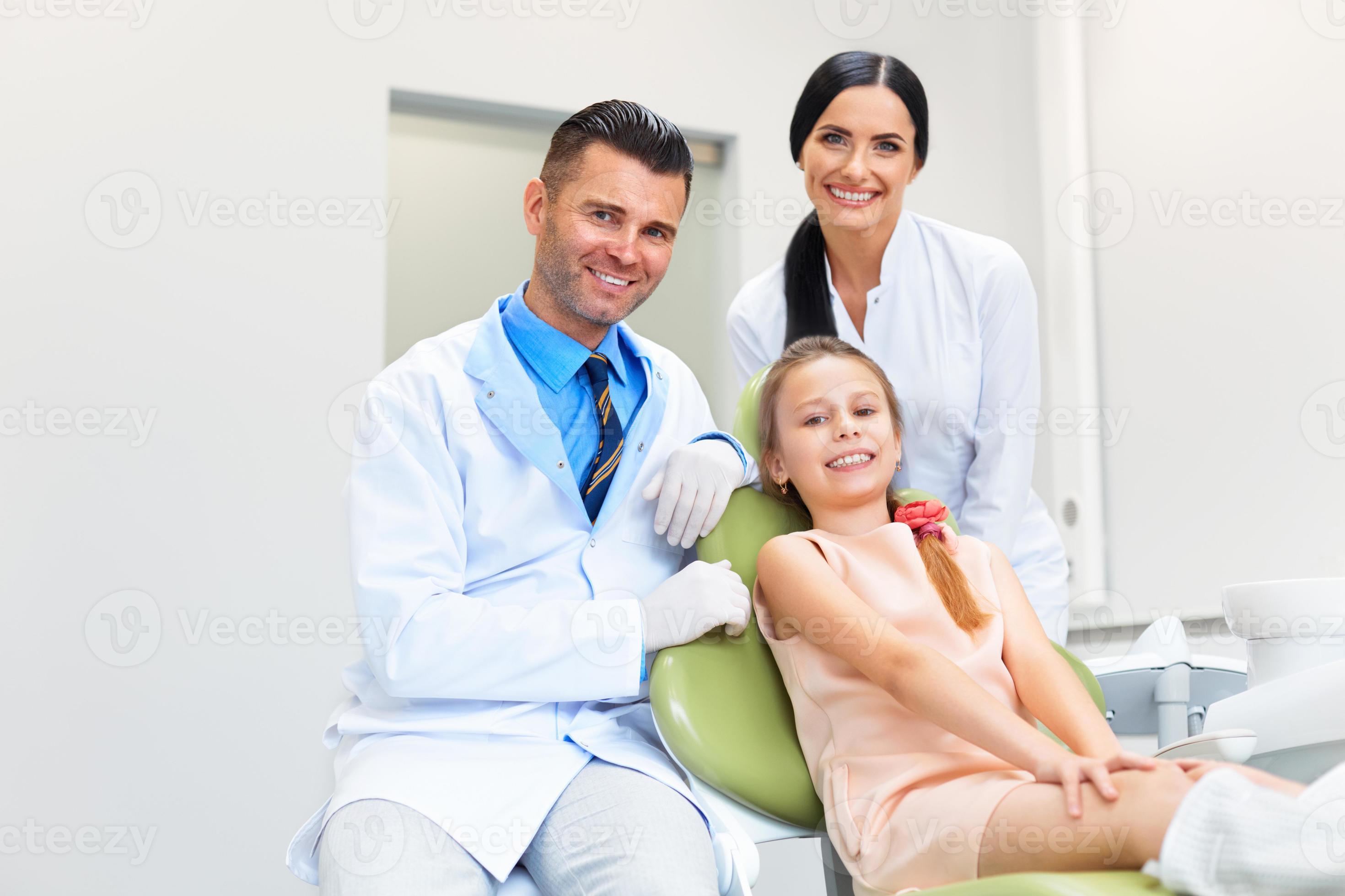 Dentist Team and Happy Patient at Dental Clinic 962041 Stock Photo at
