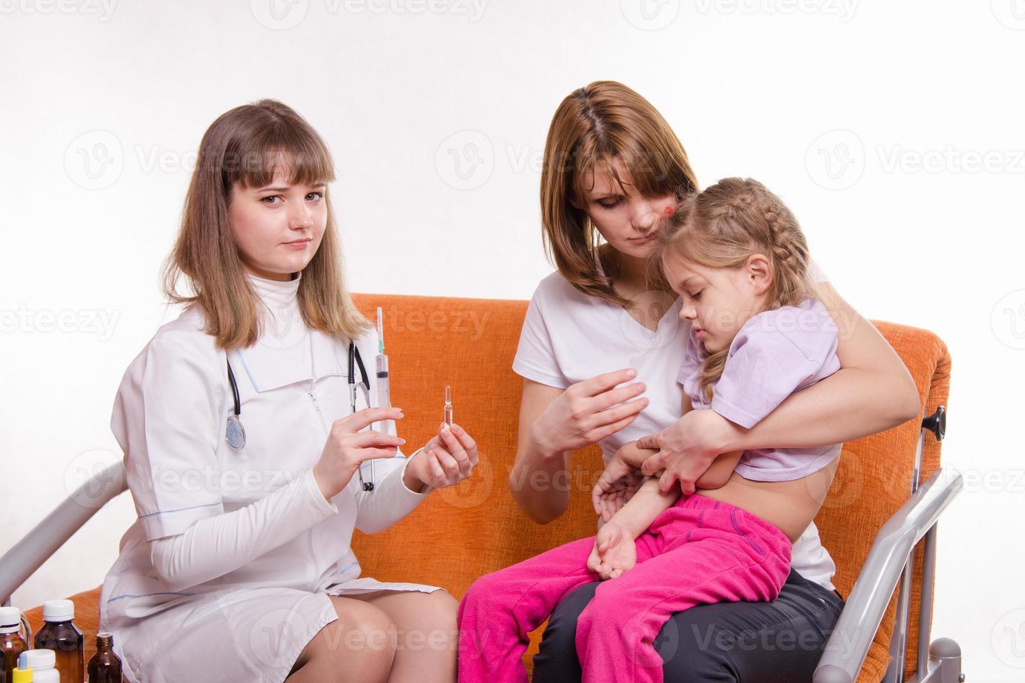 Pediatrician is going to get a shot sick child sitting photo