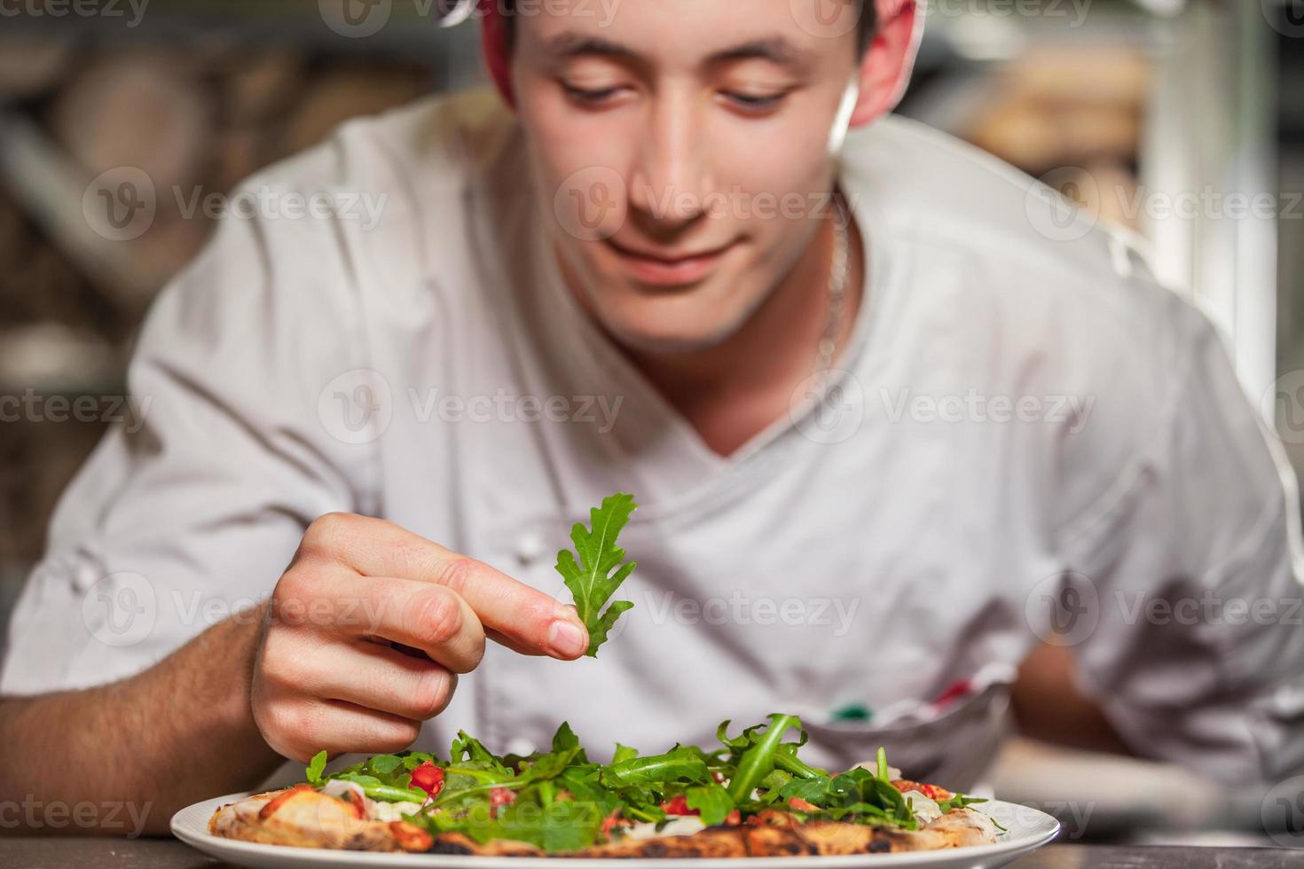 male cook preparing delicious appetizer photo