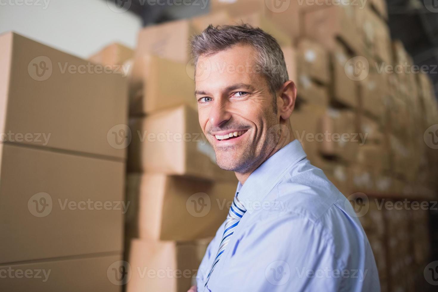 Smiling male manager in warehouse photo