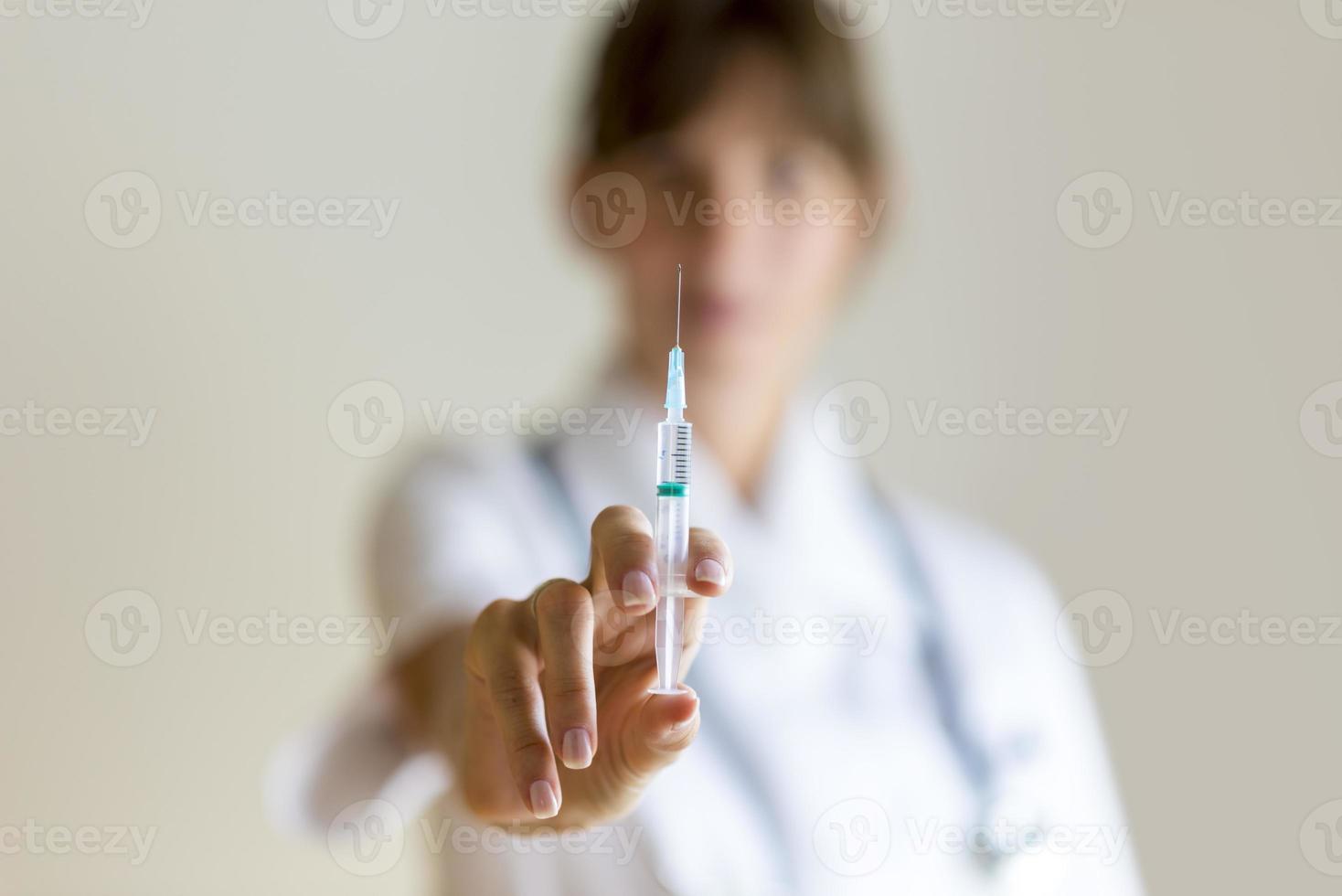Nurse holding an injection needle photo