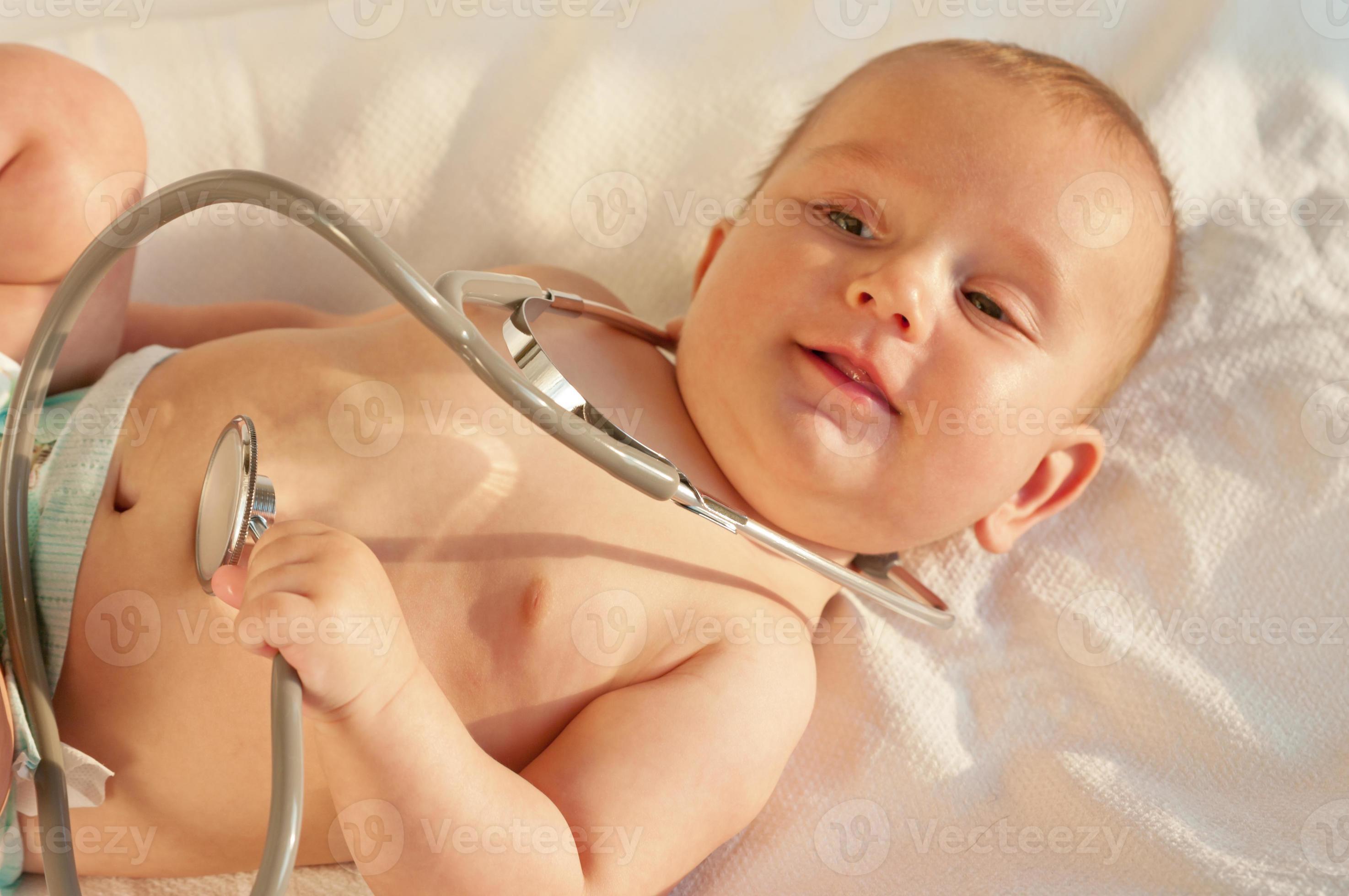 Baby playing with a stethoscope photo