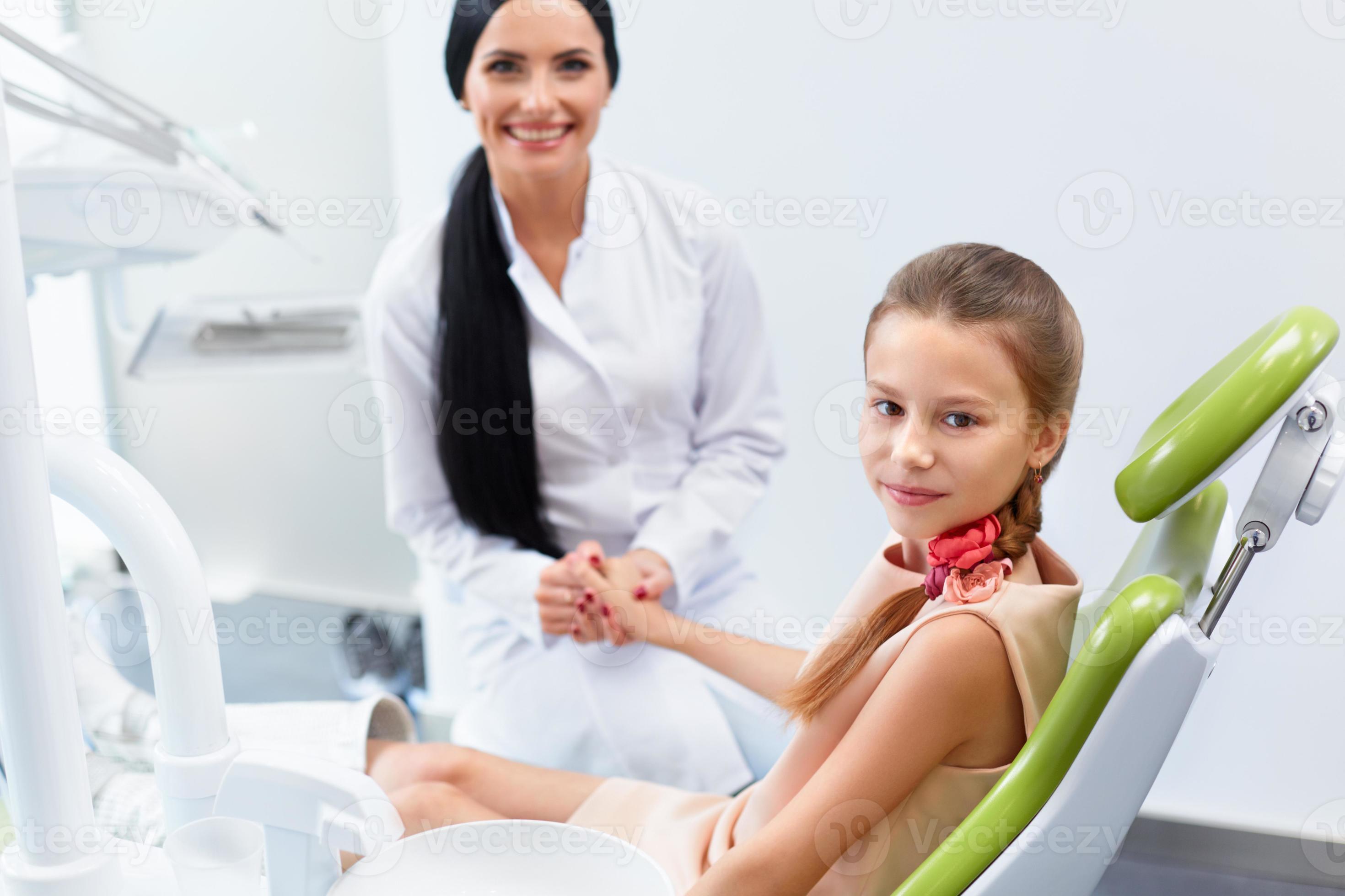 Dentist and Patient in Dentist Office. Child in Dental Chair photo
