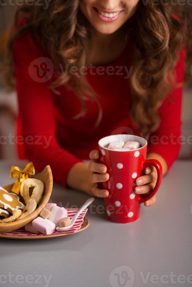 Woman having cup of hot chocolate and Christmas sweets. Closeup photo